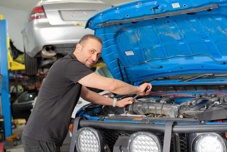 Mechanic servicing 4WD engine